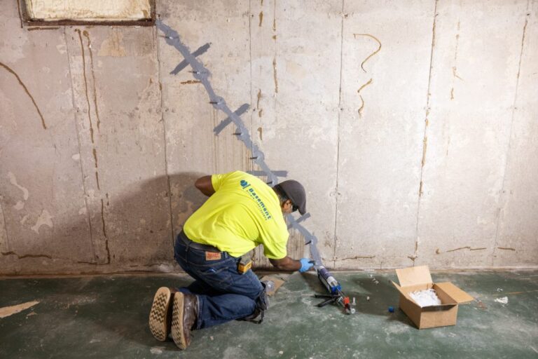 Professional inspecting a foundation crack before repair