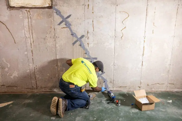 Professional inspecting a foundation crack before repair