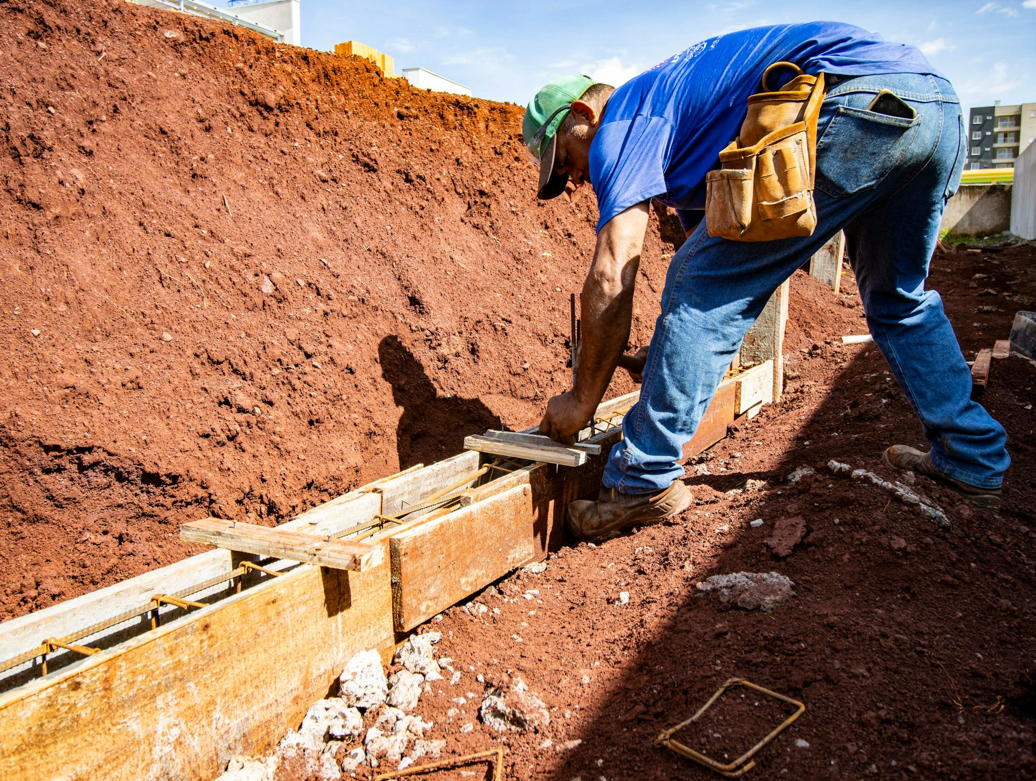 Male construction worker building a foundation outdoors in Londrina, Brazil.
