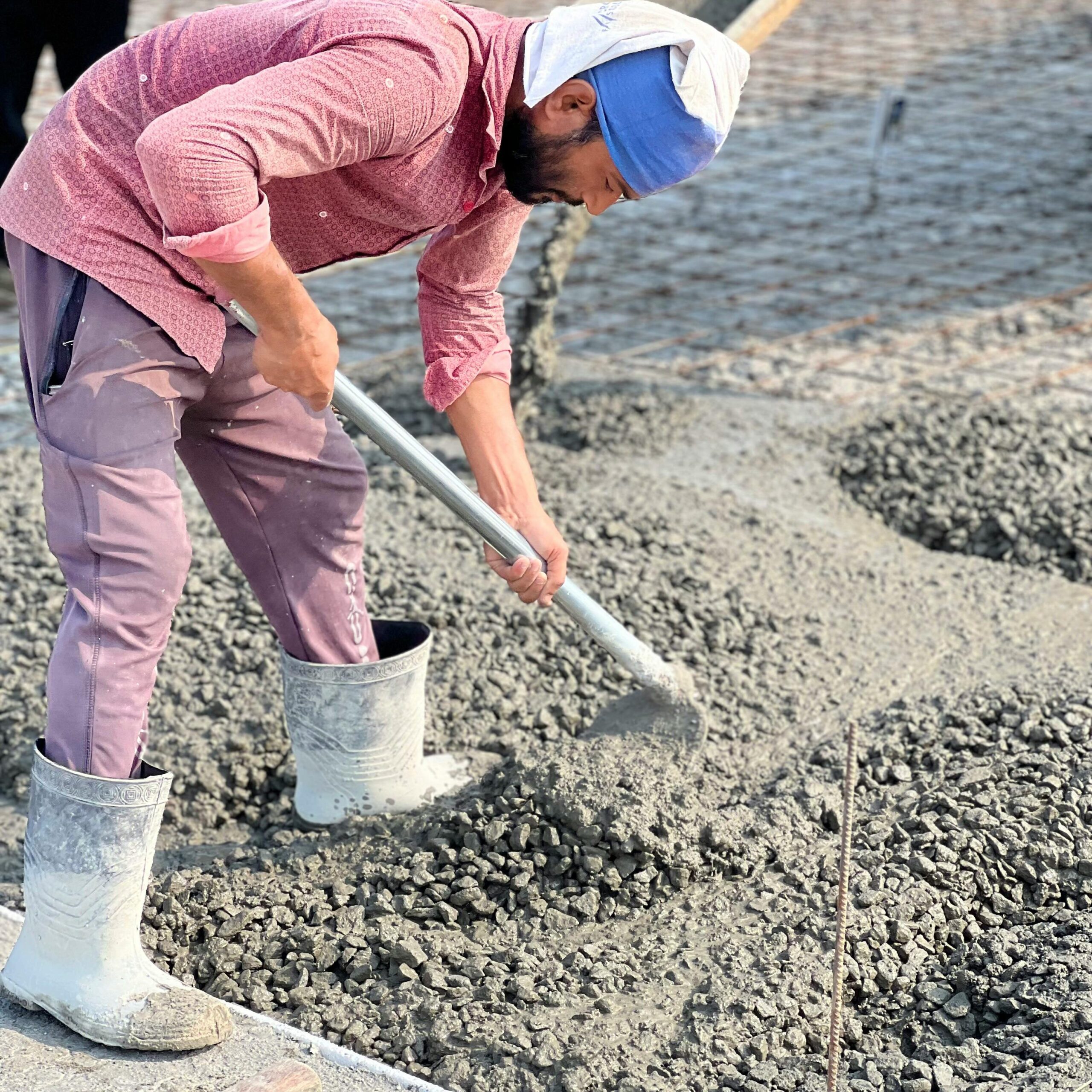 Fresh concrete being placed where workability affects compaction and finishing