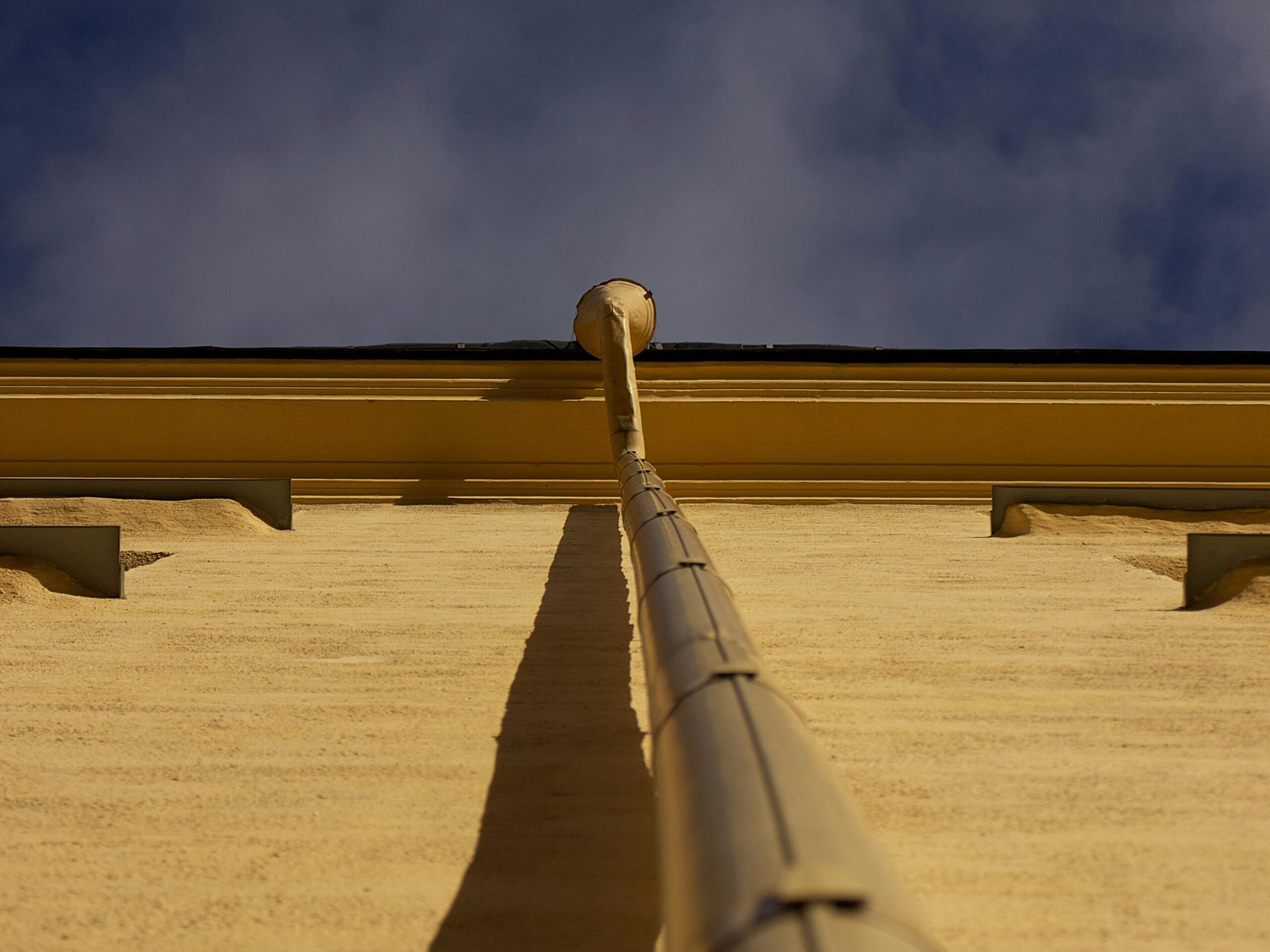 Roof downspout carrying runoff from a hot dry climate home