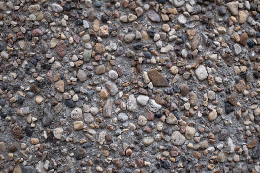 Close-up of exposed aggregate concrete surface with visible stone and gravel texture